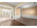 Spacious living room featuring neutral walls, carpeted floors and natural light at 6005 Pattingham Dr, Roswell, GA 30075