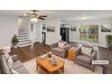 Bright living room with hardwood floors, ceiling fan, and sliding door to deck at 43 Landmark Sw Ln, Marietta, GA 30060