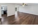 Open-concept living room with hardwood floors, white walls and walk out access at 43 Landmark Sw Ln, Marietta, GA 30060