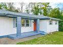 Charming entryway with red door, blue shutters, and gray porch at 1877 Glenmar Dr, Decatur, GA 30032