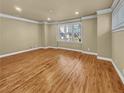 Bright living room featuring hardwood floors, neutral paint, and a large window at 3628 Princeton Ave, Atlanta, GA 30337