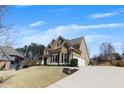Side view of a well-maintained two-story home with an attached garage and a neatly landscaped yard at 112 Bluestone Ct, Acworth, GA 30101