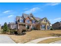 Beautifully landscaped front yard and charming two-story home with a welcoming entrance at 112 Bluestone Ct, Acworth, GA 30101