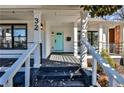 Inviting front porch featuring black trim and a bright teal front door at 32 Howell Se St, Atlanta, GA 30312