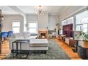 Open living room with hardwood floors, gray paint, and a brick fireplace at 32 Howell Se St, Atlanta, GA 30312