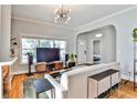 Comfortable living room featuring hardwood floors, modern lighting, and ample natural light at 32 Howell Se St, Atlanta, GA 30312