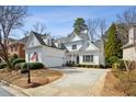 Inviting two-story home featuring white siding, manicured landscaping, and a spacious driveway at 1811 Paces Ferry Se Ct, Smyrna, GA 30080