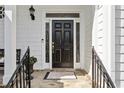 Elegant black front door with decorative sidelights and brass hardware at 1811 Paces Ferry Se Ct, Smyrna, GA 30080