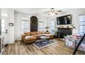 Spacious living room with hardwood floors, a leather sofa, a fireplace, and plenty of natural light at 1888 Mallard Nw St, Atlanta, GA 30318