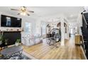 Bright living room with wood floors, fireplace, and open concept design flowing into the dining area at 1888 Mallard Nw St, Atlanta, GA 30318