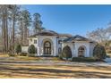 Beautiful home with well-maintained landscaping, circular driveway, and grand architectural features at 490 Birkdale Dr, Fayetteville, GA 30215