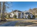 Stunning house with circular driveway, well-manicured lawn and architectural details at 490 Birkdale Dr, Fayetteville, GA 30215