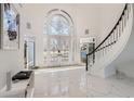 Bright foyer with stunning architectural windows and a curved staircase, all illuminated by natural light at 490 Birkdale Dr, Fayetteville, GA 30215