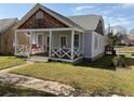 Cozy home featuring a quaint front porch with decorative railings and inviting curb appeal at 23 Poplar St, Porterdale, GA 30014
