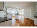 Bright, neutral kitchen with stainless steel appliances, white cabinets, and hardwood floors at 3968 Belle Glade Ct, Snellville, GA 30039