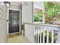Condo entrance featuring a private porch with a black front door and white railing at 402 Bainbridge Dr, Atlanta, GA 30327