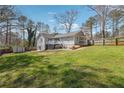 Large, grassy backyard with a deck and patio area, perfect for outdoor entertaining at 596 Frank Kirk Nw Rd, Kennesaw, GA 30152