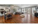 Open concept living area with hardwood floors, vaulted ceilings, and access to the backyard at 596 Frank Kirk Nw Rd, Kennesaw, GA 30152