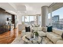 Modern living room features a plush sofa, city views, hardwood floors and sleek decor at 1080 Peachtree Ne St # 2011, Atlanta, GA 30309