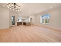 Bright and airy living room showcasing hardwood floors, recessed lighting, and seamless flow to the kitchen at 115 Alcovy Ter, Alpharetta, GA 30009