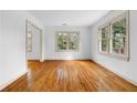 Bright and airy living room with gleaming hardwood floors and large windows at 1179 Aleamo Dr, Marietta, GA 30062