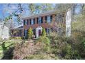 Traditional brick home featuring a well-maintained front yard and a red door at 4203 Deerbrook Sw Way, Lilburn, GA 30047