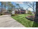 Traditional brick home featuring a well-maintained lawn and a driveway leading to a two-car garage at 4203 Deerbrook Sw Way, Lilburn, GA 30047