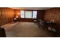 Inviting dining room with classic wood paneling and neutral carpeting, perfect for Gathering meals at 6385 Gordon St, Lithia Springs, GA 30122