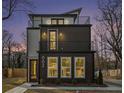 Nighttime exterior view of a modern home featuring a balcony and inviting lighting, enhancing its curb appeal at 662 S Grand Nw Ave, Atlanta, GA 30318