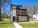 Charming exterior of a two-story home featuring a balcony, well-manicured lawn, and inviting curb appeal at 662 S Grand Nw Ave, Atlanta, GA 30318