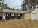 Ranch style home with light yellow siding, dark shutters, and an attached single car garage at , Kennesaw, GA 30152