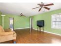 Spacious living room with hardwood floors, ceiling fan, and abundant natural light creating a warm atmosphere at 3480 Beech Dr, Decatur, GA 30032