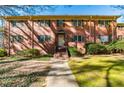 Classic brick building featuring symmetrical windows with dark shutters, inviting entrance and manicured landscaping at 430 Lindbergh Ne Dr # A1, Atlanta, GA 30305