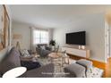 Staged living room with modern gray furniture, area rug, and plenty of natural light at 430 Lindbergh Ne Dr # A1, Atlanta, GA 30305