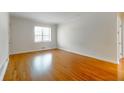 Bright, empty room featuring beautiful hardwood floors, a large window and neutral walls at 430 Lindbergh Ne Dr # A1, Atlanta, GA 30305