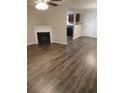 Cozy living room with a fireplace and modern floors, flowing into the kitchen at 5175 Hanover St, Atlanta, GA 30349