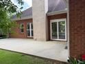 Back patio with sliding doors and brick columns for entertaining or relaxing outdoors at 704 Euel Dr, Mcdonough, GA 30252