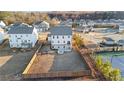Aerial view of a spacious backyard with a fence, fire pit, and access to tennis courts at 7630 Rambling Vale, Cumming, GA 30028