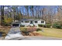 Charming ranch home with black garage, landscaped yard and stone accents at 935 Tiber Cir, Alpharetta, GA 30022