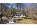 Aerial view of a single story home with mature trees, landscaping and driveway at 935 Tiber Cir, Alpharetta, GA 30022
