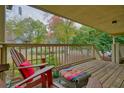 Comfortable seating on a covered deck with wood floors and pleasant views of the trees at 1507 Country Park Se Dr, Smyrna, GA 30080