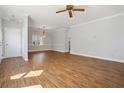 Spacious living area features beautiful hardwood floors and a decorative ceiling fan at 4010 Arborwood Ln, Tucker, GA 30084