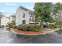 Charming townhome featuring a two-car garage, second story balcony, and professionally landscaped yard at 50 Sycamore Sta, Decatur, GA 30030