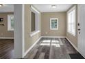 Cozy entryway with wood-look floors, natural light, and updated white trim, creating a cheerful space at 5125 West St, Forest Park, GA 30297