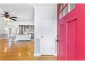 Open floor plan showing hardwood floors, a ceiling fan, and a front door entrance at 712 Berts Nw Cir, Lilburn, GA 30047