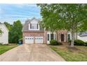 Charming two-story brick home with a two-car garage and well-manicured landscaping at 980 Charter Club Dr, Lawrenceville, GA 30043