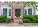 Welcoming front entrance with brick steps, lush landscaping, and a stylish front door at 980 Charter Club Dr, Lawrenceville, GA 30043