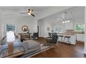 Open concept living room and kitchen with hardwood floors, white wood trim, and modern decor at 1464 Sagamore Ne Dr, Atlanta, GA 30345