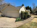 Attached garage with driveway and manicured garden beds at 4835 John Burruss Rd, Cumming, GA 30040