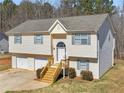 Inviting two-story home featuring a 2-car garage, new roof, and charming front entrance with new wood steps at 195 Brighton Dr, Covington, GA 30016